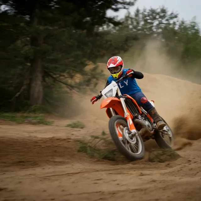 AI video generator example of a motocross dirt bike rider kicking up dust